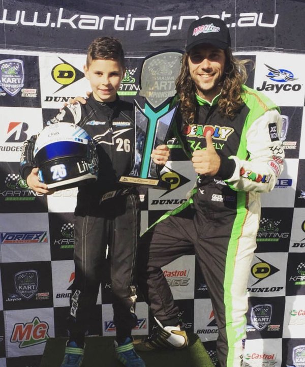 Kai Allen with a team mate and their trophies at a karting.net.au event