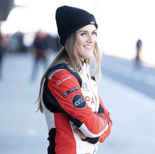 Chelsea Angelo in a red and white race suit and black beanie