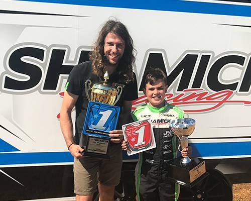 James Wharton with David Sera and a row of trophies